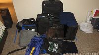 Overview of all luggage items including large upright suitcases, briefcase, duffel bags, and packing cubes
