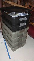 Stacked view of six large plastic totes filled with freeze dried food bags.