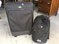 Samsonite luggage and Swiss Gear backpack together showing size and overall condition