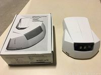 White Lumacell emergency lighting battery unit alongside its box, showing front and top design.