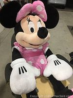 Another front view seated photo showing entire plush doll including oversized white gloves, pink dress, and large shoes.