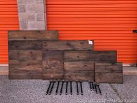 Wooden shelf panels laid flat showing dark rustic wood finish with knots and natural grain