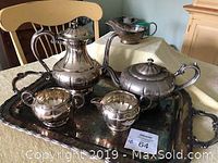 Full set of silver plated coffee pot, teapot, creamer, sugar bowl on the serving tray along with a gravy boat.