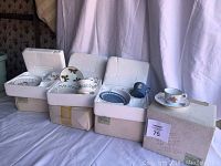 Four sets of tea cups and saucers in original styrofoam and boxes from The Danbury Mint.