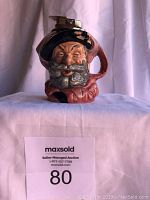 Front view of Royal Doulton Falstaff Toby Jug Lighter showing the detailed ceramic figure and lighter component on top.