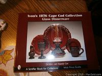 Cover of Avon 1876 Cape Cod Collection Glass Dinnerware book by Debbie and Randy Goe, featuring ruby red glassware.
