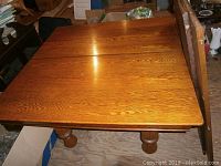 Top-down view of square tabletop assembled without leaves