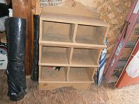 Front view of vintage wooden chicken nesting shelf showing six compartments and decorative top with star cutout.