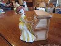 Front side view showing young lady seated at piano figurine music box
