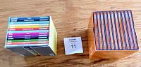 Top view of the full box set showing 12 CDs and user guide, placed on wooden surface.