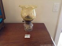 Full oil lantern showing the yellow-tinted scalloped top glass globe with floral etching and clear glass reservoir base with metal wick holder.