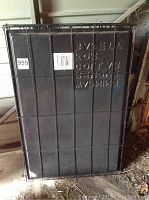 Photo of plastic base side of the cage showing raised warning text and barcode sticker.