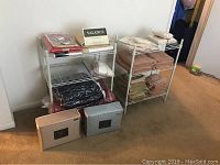 Wide shot of shelves with linens, towels, sheets, and window valance boxed items