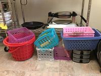 Photo of various plastic storage containers in multiple colors including round baskets, small drawers, and rectangular baskets.
