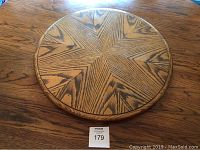 Top-down view of round oak Lazy Susan displaying star-pattern wood grain and natural finish.