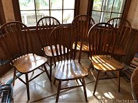 Six oak side chairs grouped together near window showing full view of lot