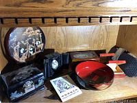 Photo overview of all items including carved panda scene, boxes, bowl, carved egg, and paper art