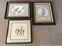Photo showing three framed prints: eagle catching fish, two quails, and a grazing horse.