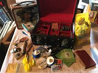 Overview of lot items including lunch box, jewelry box, darts, pocket knife, campaign buttons