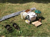 Overview of various outdoor items including hammock, lanterns, bird feeder, bird and squirrel food, roasting forks, and containers.
