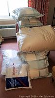 Comforter with plush filling and pillows stacked on bed, showing color and pattern