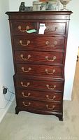 Front view of Century tall chest dresser with 8 drawers, showing brass drop bail handles and beaded molding.