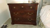 Front-left view of night stand showing three drawers and marble top