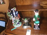 Photo showing all three figurines on a wooden surface: 13 inch Highlander, brass fox bust, and 11 inch Chelsea House fox figurine