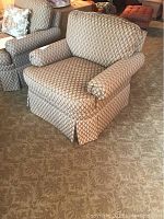 Full view of the upholstered club chair showing diamond pattern fabric in beige, taupe, and burgundy.