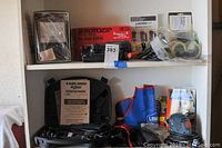 Shelf showing original box for Rotozip Pro Series rotary tool, safety goggles, accessories, and accessories box