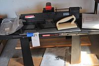 Photo of a black Craftsman Deluxe Router Table with push block and side rails, displaying its physical condition and accessories.