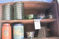 Image showing glass containers, tea tins, a flowered ceramic planter, a vintage coffee grinder, and a metal iron