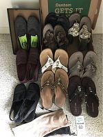 Pairs of ladies shoes including Nike Air Max slip-ons and various sandals arranged on carpeted floor, showing top view and full lot