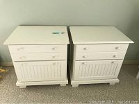 Front view of two white cottage style nightstands side by side