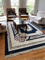 Area rug displayed under living room furniture showing overall design and size.
