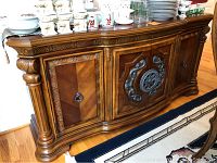 Full view of entire buffet on hardwood floor with tableware on top