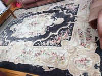Large 9'x12' rug laid out on hardwood floor showing central floral medallion and border