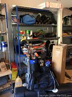 Full view of metal wire shelving unit with items stored on shelves and some accessories around it, showcasing size and structure