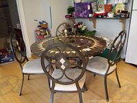 Table and four chairs arranged in dining area