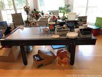 Full view of air hockey table with mixed items on top and sides