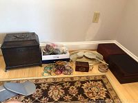 Wide view of all lot contents with two humidors, box of bangles, vanity set, wood boxes, and watch