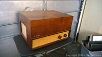 Front side view of the wood cabinet record player showing the Webcor logo and speaker grille.