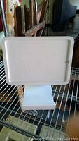 Front view of the white Square swivel stand showing the flat rectangular platform and solid base with Square logo.