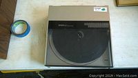 Full view of the Technics SL-5 turntable with dust cover closed, silver top and black platter visible.