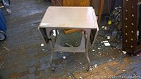 Photo of vintage steel typewriter table with fold-out tray in closed position
