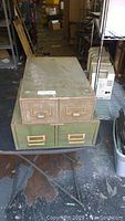 Two industrial steel metal card catalogue drawers stacked, showing a top view and overall condition