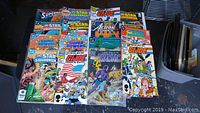 Top view of assorted Bronze Age DC and Marvel comics showing covers of Star Squadron, Superman, G.I. Joe, Action Comics, The Phantom, and more.