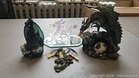 Four dragon figurines displayed on a table, showing overall lot contents.