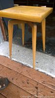 Side view of MCM Superior Table showing tapered legs and wood finish.