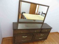 Front view of wood dresser with attached mirror showing drawer details and finish.